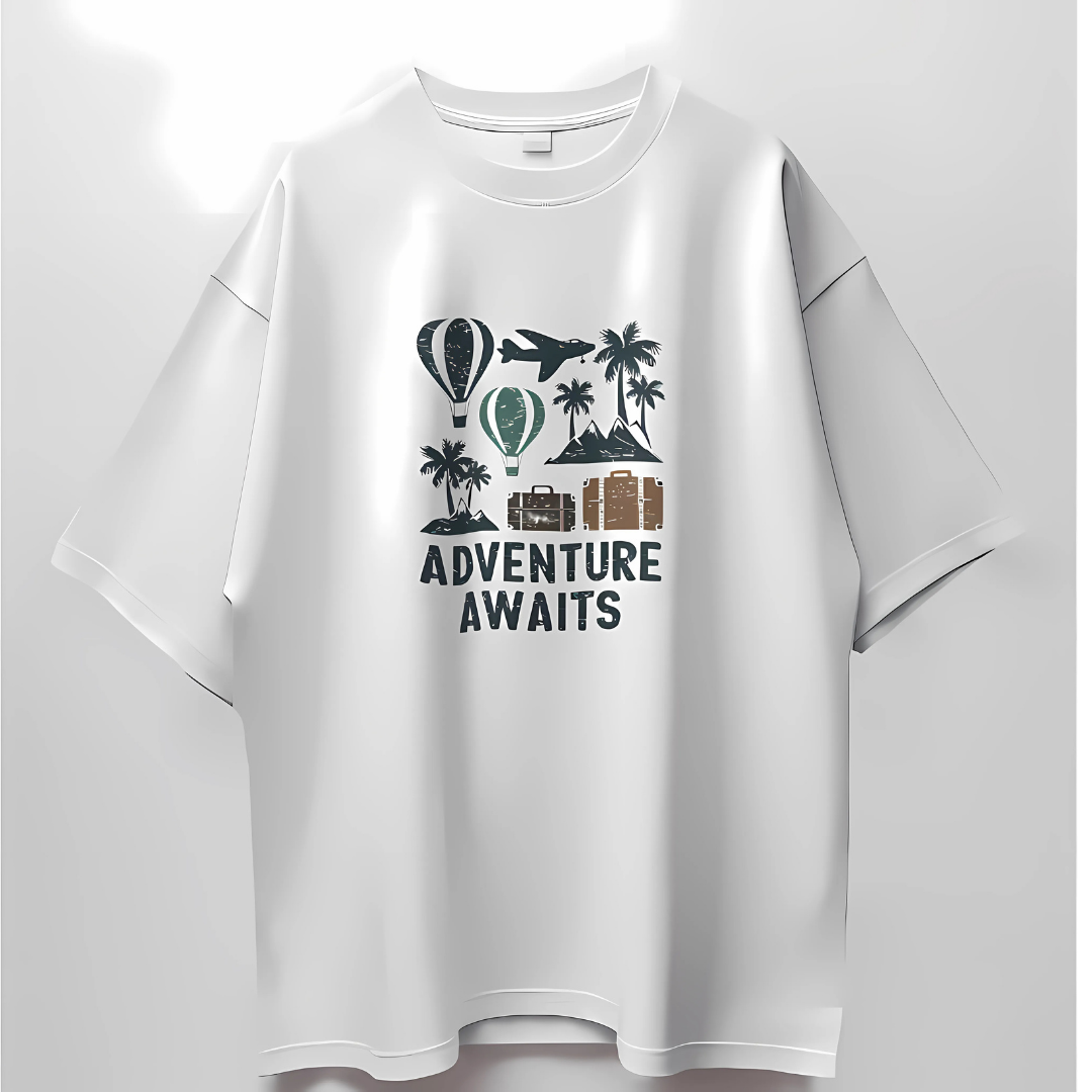 White T-shirt featuring a travel-themed design with hot air balloons, airplane, palm trees, mountains, and the text 'Adventure Awaits