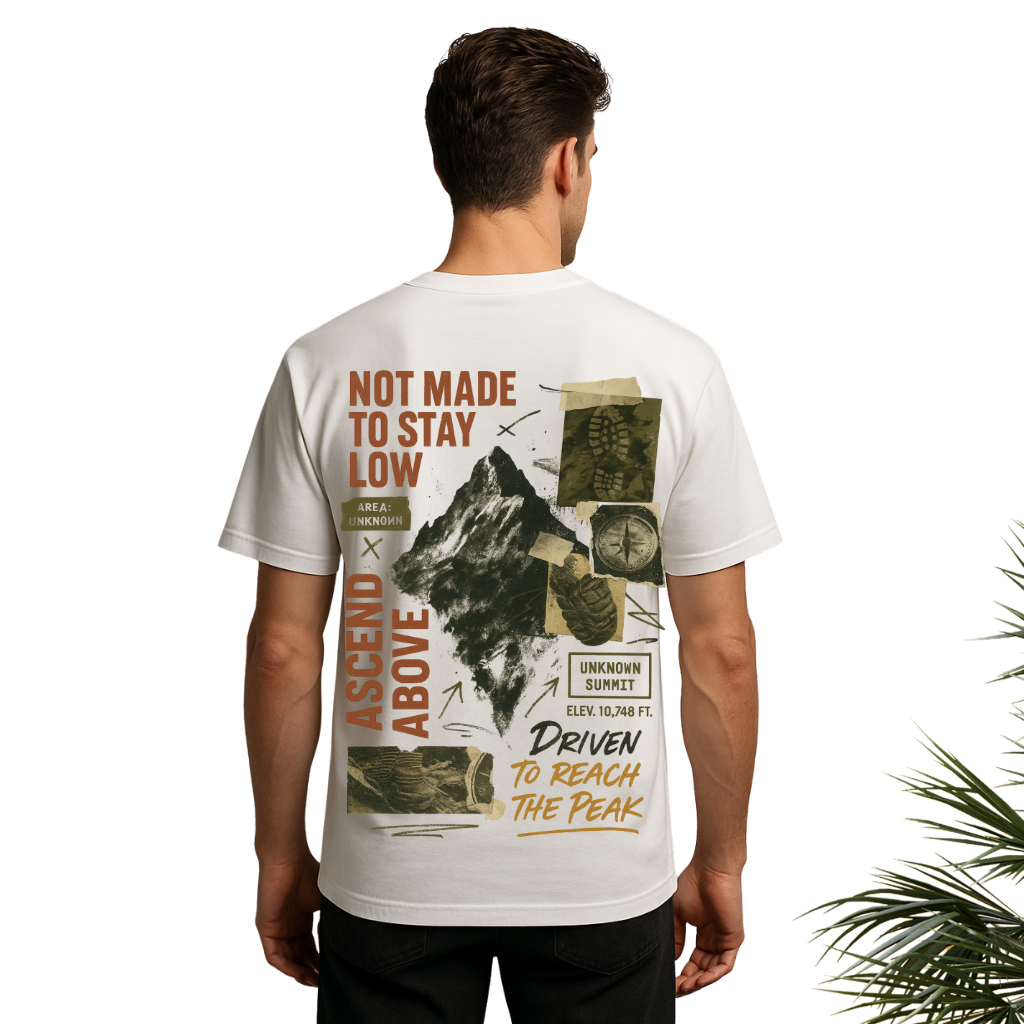 Back of white oversized t-shirt with mountain illustration and motivational text for streetwear styling.